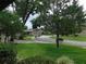 Landscaped community street showcasing well-maintained lawns and mature trees enhancing curb appeal at 3856 Ne 17Th Street Cir, Ocala, FL 34470