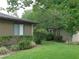 Well-maintained yard with green grass and manicured bushes offer curb appeal at 3856 Ne 17Th Street Cir, Ocala, FL 34470