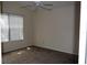 Carpeted bedroom featuring a ceiling fan and natural light from the window at 3904 Ne 22Nd St, Ocala, FL 34470