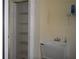 Utility sink and laundry area with washer/dryer hookups and storage shelving at 3904 Ne 22Nd St, Ocala, FL 34470