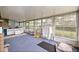Bright sunroom enclosed with large windows, great natural light, and tiled counter space at 4025 Ne 18Th St, Ocala, FL 34470
