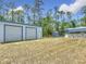 A large lawn has a metal building with roll-up doors, a shed, and an above-ground pool at 4258 Sw Zinnia Ct, Dunnellon, FL 34431