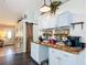 Bright breakfast bar with wood counter, white cabinets and accent wall decorations at 4258 Sw Zinnia Ct, Dunnellon, FL 34431