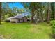 Spacious backyard featuring mature trees, green lawn, and ample space for outdoor enjoyment at 4465 Se 48Th Place Rd, Ocala, FL 34480