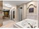 A luxurious bathroom with a soaking tub, access to the main bedroom, and elegant decor at 4465 Se 48Th Place Rd, Ocala, FL 34480