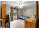 Well-lit bedroom features a large window, ceiling fan, closet, and neutral decor at 4465 Se 48Th Place Rd, Ocala, FL 34480