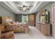 Large bedroom with a tray ceiling, ceiling fan, and ample natural light at 4465 Se 48Th Place Rd, Ocala, FL 34480