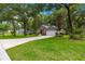 Well-manicured lawn, mature trees, and attractive landscaping enhance the curb appeal of this home at 4465 Se 48Th Place Rd, Ocala, FL 34480