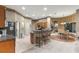 Open-concept kitchen with stainless steel appliances, breakfast bar, and adjoining dining area at 4465 Se 48Th Place Rd, Ocala, FL 34480