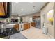 Eat-in kitchen with stainless steel appliances, bar area, and an opening to the living room at 4465 Se 48Th Place Rd, Ocala, FL 34480