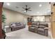 Spacious living area with two reclining sofas, neutral paint, and a ceiling fan at 4465 Se 48Th Place Rd, Ocala, FL 34480