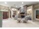 Cozy living room featuring a stone fireplace, carpeted floors and an archway at 4465 Se 48Th Place Rd, Ocala, FL 34480