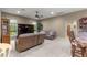 Comfortable living room featuring dual reclining sofas, built-in entertainment center, and neutral decor at 4465 Se 48Th Place Rd, Ocala, FL 34480