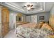 Main bedroom featuring a tray ceiling, fan, closet and entry to the main bath at 4465 Se 48Th Place Rd, Ocala, FL 34480