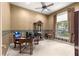 Office with wooden desk, ceiling fan, neutral walls, and a sunlit window at 4465 Se 48Th Place Rd, Ocala, FL 34480