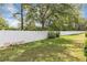 Large backyard with a well-maintained white fence and lush green grass perfect for outdoor activities at 5151 Sw 39Th St, Ocala, FL 34474
