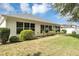 Well-manicured backyard with a lush green lawn, complemented by mature landscaping and a white house facade at 5151 Sw 39Th St, Ocala, FL 34474
