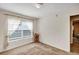 Neutral bedroom with natural light streaming through the window and carpet floors at 5151 Sw 39Th St, Ocala, FL 34474