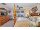 Comfortable main bedroom featuring a four-poster bed, a dresser with a television, and a ceiling fan at 5151 Sw 39Th St, Ocala, FL 34474