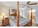 Elegant main bedroom featuring a four-poster bed, an ensuite bathroom, and a ceiling fan at 5151 Sw 39Th St, Ocala, FL 34474