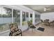 Enclosed sunroom featuring many windows for natural light and tile flooring at 5151 Sw 39Th St, Ocala, FL 34474