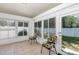 Sunroom with neutral tile flooring, large windows, and a glass door to the backyard at 5151 Sw 39Th St, Ocala, FL 34474