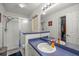 Bright bathroom featuring a white shower and white sink with blue countertop at 6127 Sw 84Th Place Rd, Ocala, FL 34476