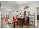 Bright dining room featuring a round table with red and gray chairs and a modern chandelier at 6127 Sw 84Th Place Rd, Ocala, FL 34476