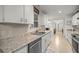 Bright kitchen featuring stainless steel appliances, granite countertops, and white cabinets at 6127 Sw 84Th Place Rd, Ocala, FL 34476