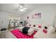 Bright living room with stylish furniture, pink accents, and a hanging chair at 6127 Sw 84Th Place Rd, Ocala, FL 34476
