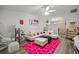 Bright living room with stylish furniture, pink accents, and a ceiling fan at 6127 Sw 84Th Place Rd, Ocala, FL 34476