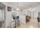 Open-concept living space with tile flooring, natural light, and a view of the adjacent sitting area at 6127 Sw 84Th Place Rd, Ocala, FL 34476