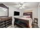 The main bedroom features an elaborate dresser, a TV, and a ceiling fan at 6127 Sw 84Th Place Rd, Ocala, FL 34476