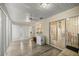 Enclosed sunroom with laminate flooring, ceiling fan, and access to the backyard through sliding doors at 6127 Sw 84Th Place Rd, Ocala, FL 34476