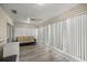Bright sunroom with laminate flooring, ceiling fan, and vertical blinds for privacy at 6127 Sw 84Th Place Rd, Ocala, FL 34476