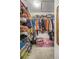 Walk-in closet, fully stocked with shelves, rods, and storage containers at 6127 Sw 84Th Place Rd, Ocala, FL 34476