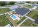 Aerial view of backyard featuring pool, hot tub, shed, patio, and white vinyl privacy fence at 6646 Sw 64Th Ave, Ocala, FL 34476