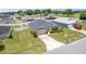 Aerial view of a well-maintained single-story home with an American flag and landscaped front yard at 6646 Sw 64Th Ave, Ocala, FL 34476