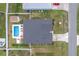 A bird's-eye view of a home with a backyard pool, hot tub, shed, patio, and large driveway at 6646 Sw 64Th Ave, Ocala, FL 34476