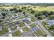 An aerial view shows neighborhood homes, green lawns, and fields, creating a serene landscape at 6646 Sw 64Th Ave, Ocala, FL 34476