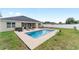 A backyard with a pool and patio seating provides space for outdoor entertaining at 6646 Sw 64Th Ave, Ocala, FL 34476