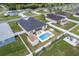 An aerial view of a fenced backyard with a pool, hot tub, shed and patio seating at 6646 Sw 64Th Ave, Ocala, FL 34476