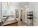 Well-lit bathroom featuring dual sinks, a framed mirror, walk-in shower, and a towel rack at 6646 Sw 64Th Ave, Ocala, FL 34476
