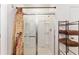 Bright bathroom with a glass shower enclosure, neutral color scheme, and useful metal shelving at 6646 Sw 64Th Ave, Ocala, FL 34476