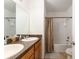 Bathroom featuring a double sink vanity, shower-tub combo, and tile flooring at 6646 Sw 64Th Ave, Ocala, FL 34476