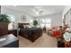 Bright bedroom features a dark wood bed set, side tables, plants, and sitting chair at 6646 Sw 64Th Ave, Ocala, FL 34476