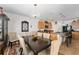 Dining room area features a chandelier, hardwood table, and an open concept kitchen at 6646 Sw 64Th Ave, Ocala, FL 34476
