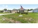 Attractive single-story home with a long driveway, two-car garage, and manicured front yard featuring an American flag at 6646 Sw 64Th Ave, Ocala, FL 34476