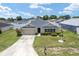 Charming single-story home featuring a well-manicured lawn and a two-car garage on a sunny day at 6646 Sw 64Th Ave, Ocala, FL 34476
