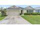 Lovely single-story home with a well-kept front lawn, two-car garage, and dark shutters accenting the windows at 6646 Sw 64Th Ave, Ocala, FL 34476